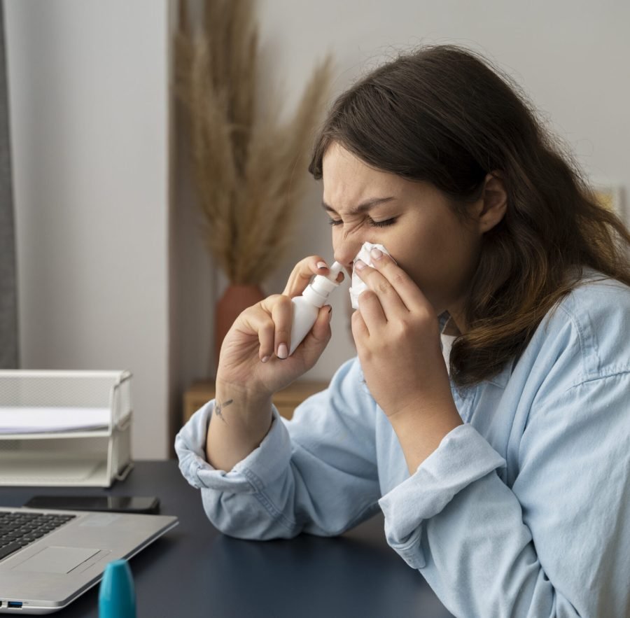 woman-holding-nasal-spray-side-view